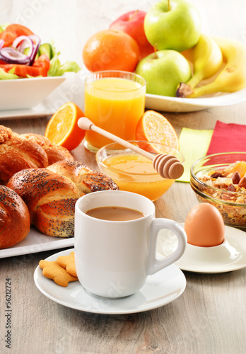 Breakfast including coffee, bread, honey, orange juice, muesli a