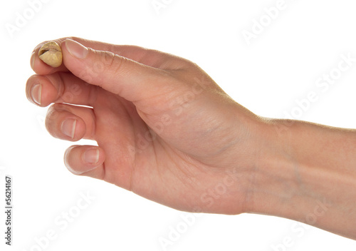 Salted and roasted pistachio nuts in a hand, isolated on white