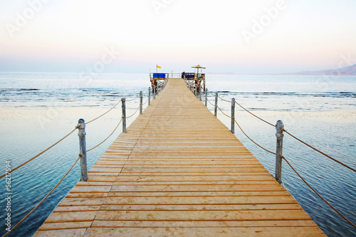 wooden platform beside sea