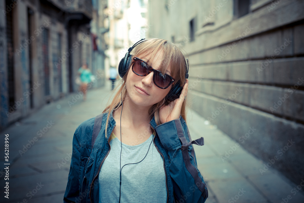 beautiful blonde woman listening to music