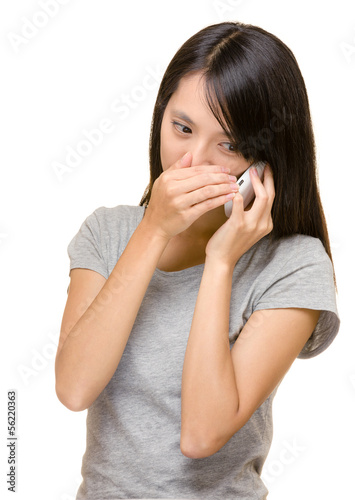 Asian woman talking phone secretly