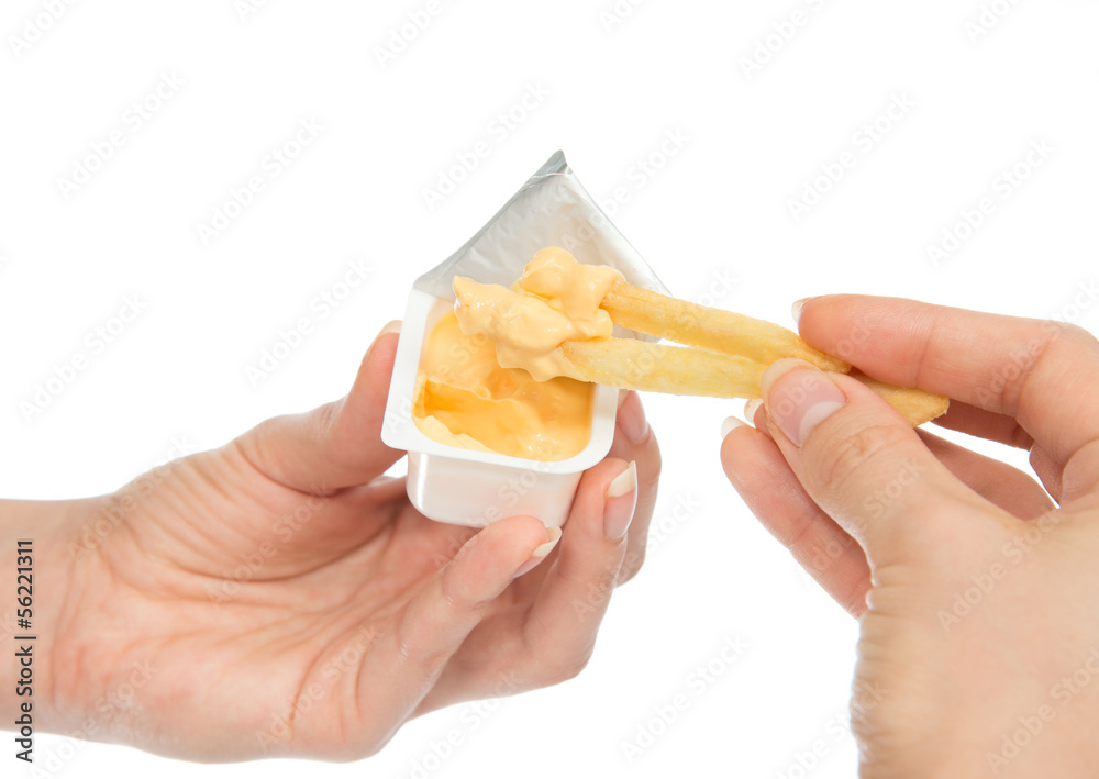 Hand dip french fries chips into cheese sauce Hand dip french fries chips into cheese sauce