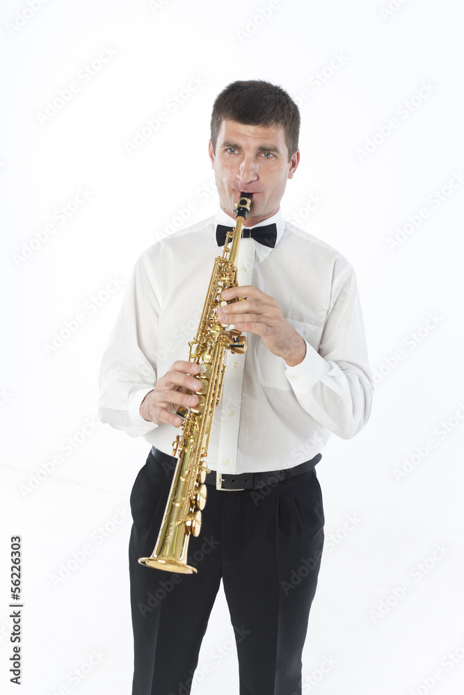 Fototapeta premium Young handsome man plays saxophone
