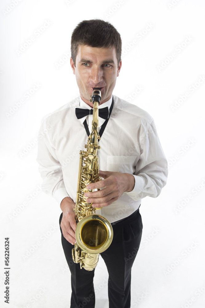 Fototapeta premium Young handsome man plays saxophone