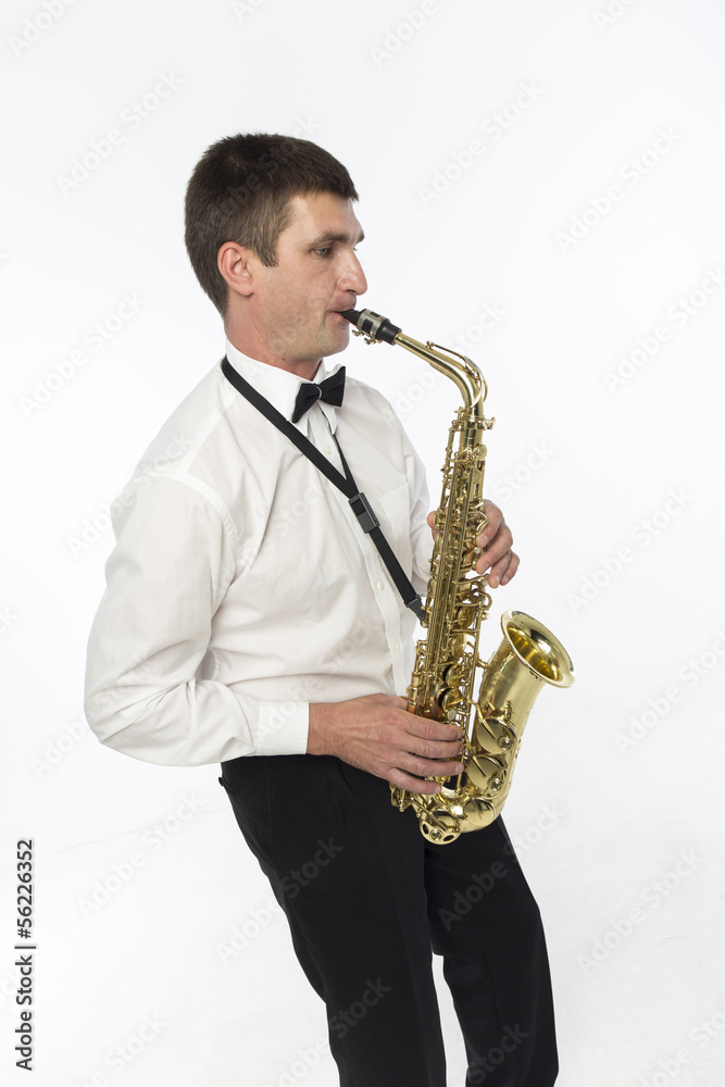 Obraz premium Young handsome man plays saxophone