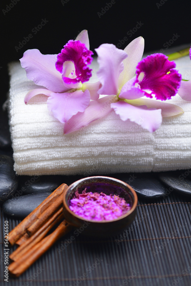 orchid on towel and stones with salt on bowl on mat orchid on towel and stones with salt on bowl on mat