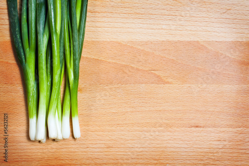 Young onion on cutting board background