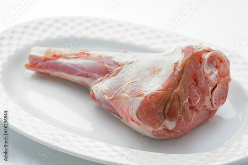 Crude whole veal shank on white tray