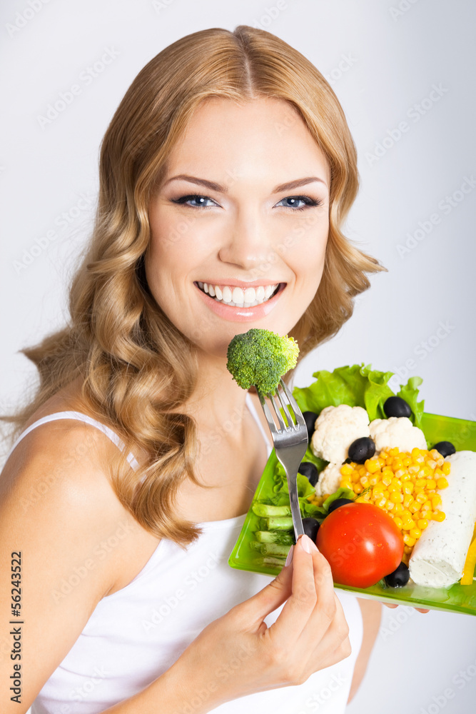 Woman with vegetarian salad, over gray Woman with vegetarian salad, over gray