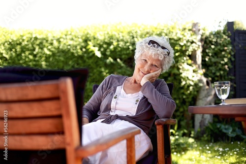 Senior woman relaxing in backyard garden