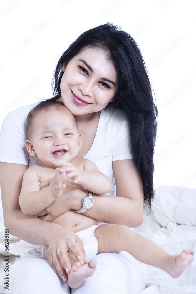 Attractive mother and baby laughing - isolated