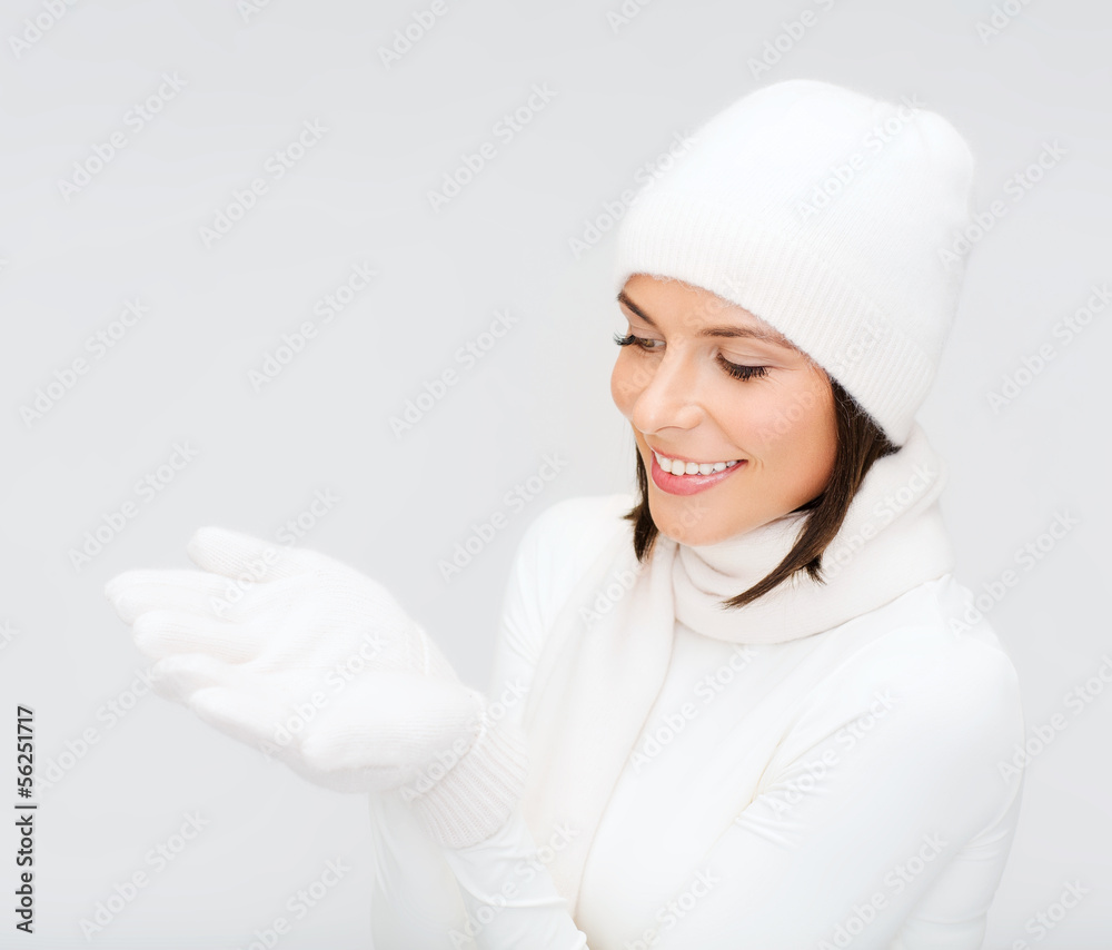 woman in winter clothes with something on palms woman in winter clothes with something on palms