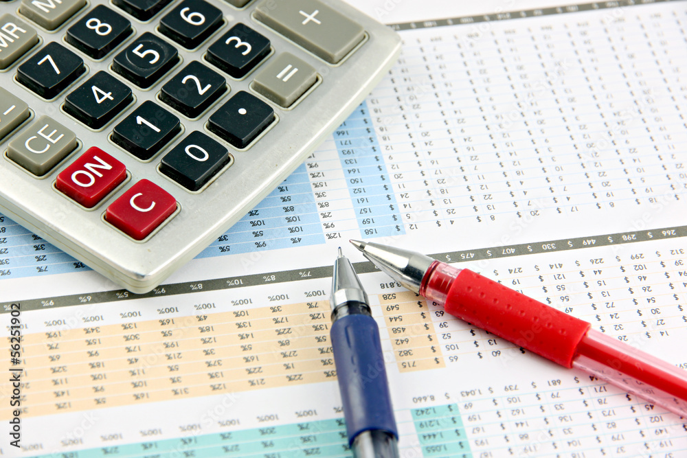 Pen and Calculator that is placed on businesses graph.