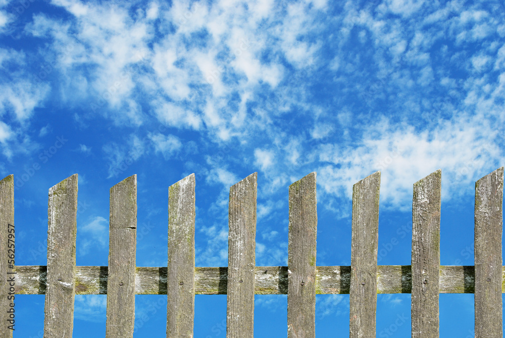 old wooden fence with cloudy sky old wooden fence with cloudy sky