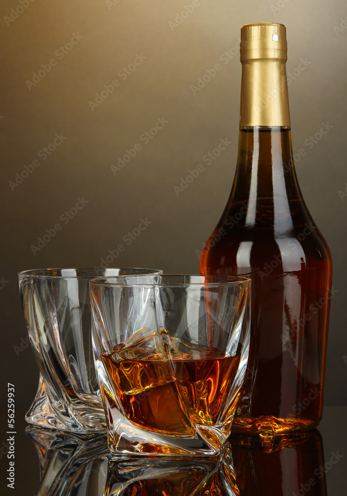 Glass of whiskey with bottle, on dark background Glass of whiskey with bottle, on dark background