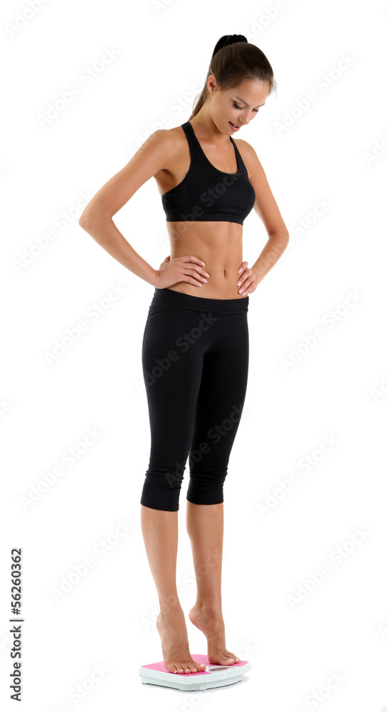 Slim young girl on scales isolated on white Slim young girl on scales isolated on white