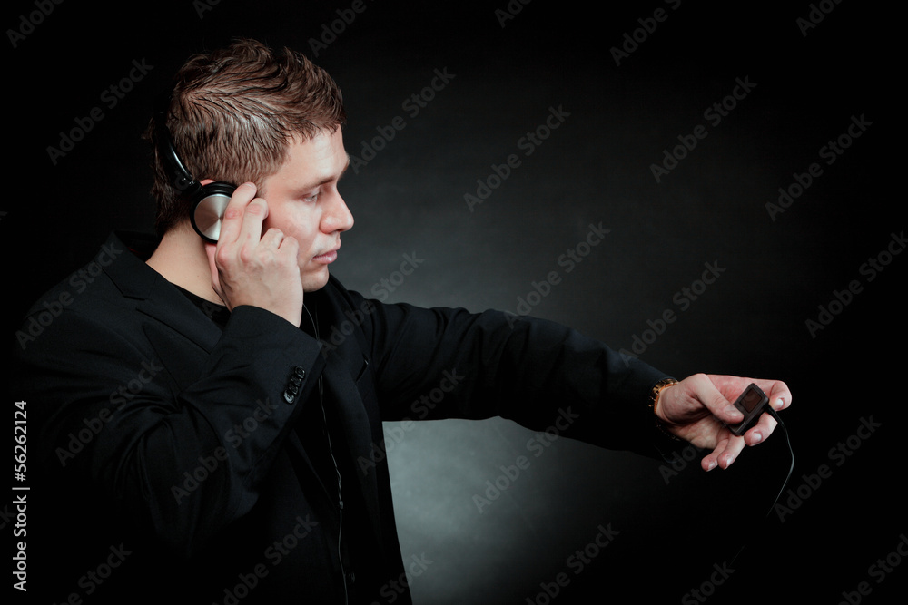 young man with headphones use mp3 music player young man with headphones use mp3 music player