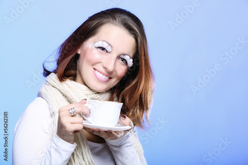 Winter makeup woman with cup of hot latte coffee