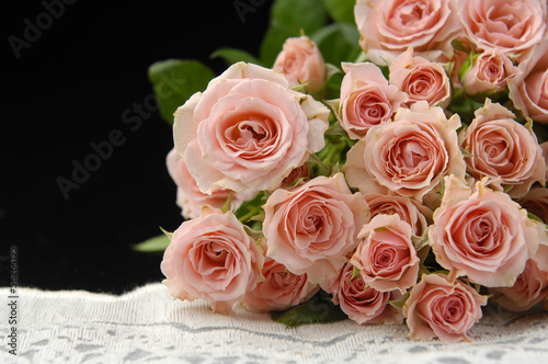 pink roses with silk on black background