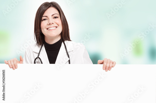 Smiling female doctor with message board
