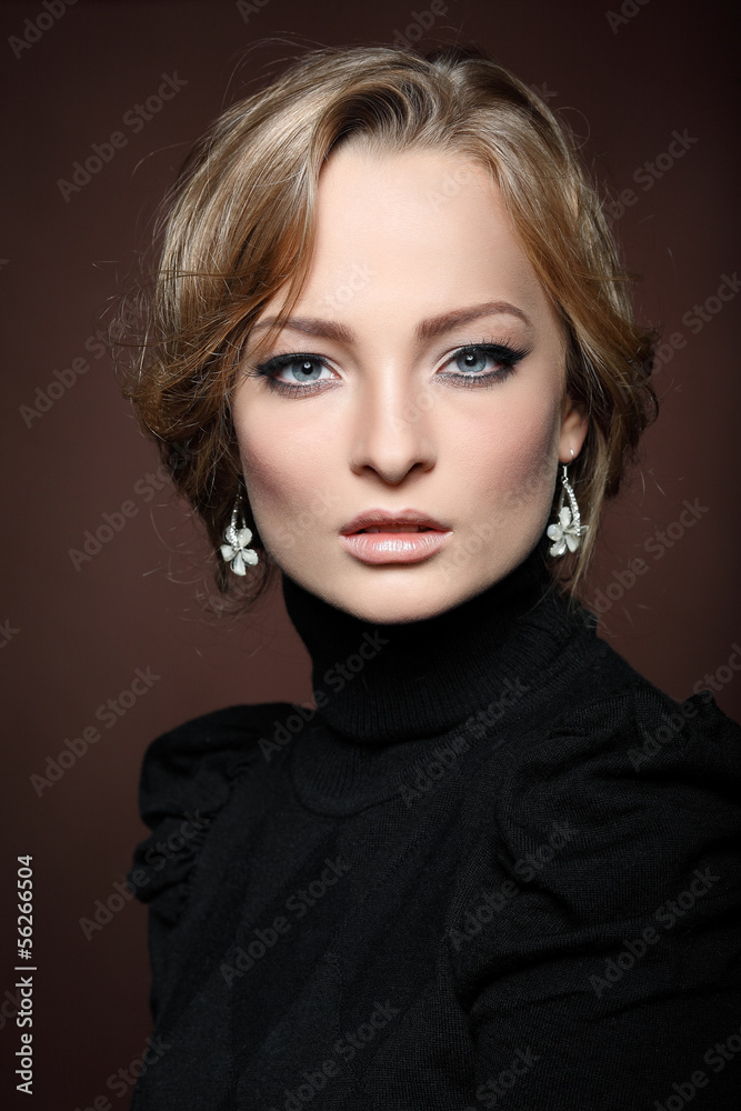 Portrait of young woman in a black jumper on a brown Portrait of young woman in a black jumper on a brown