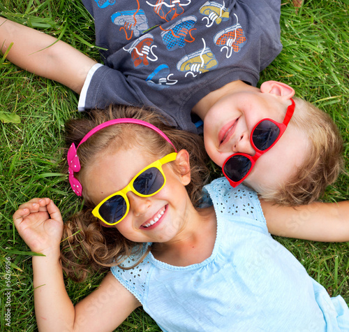 Picture presenting kids relaxinng on the grass