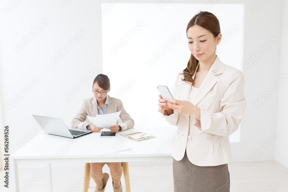 Beautiful asian businesswomen using a cellular Beautiful asian businesswomen using a cellular