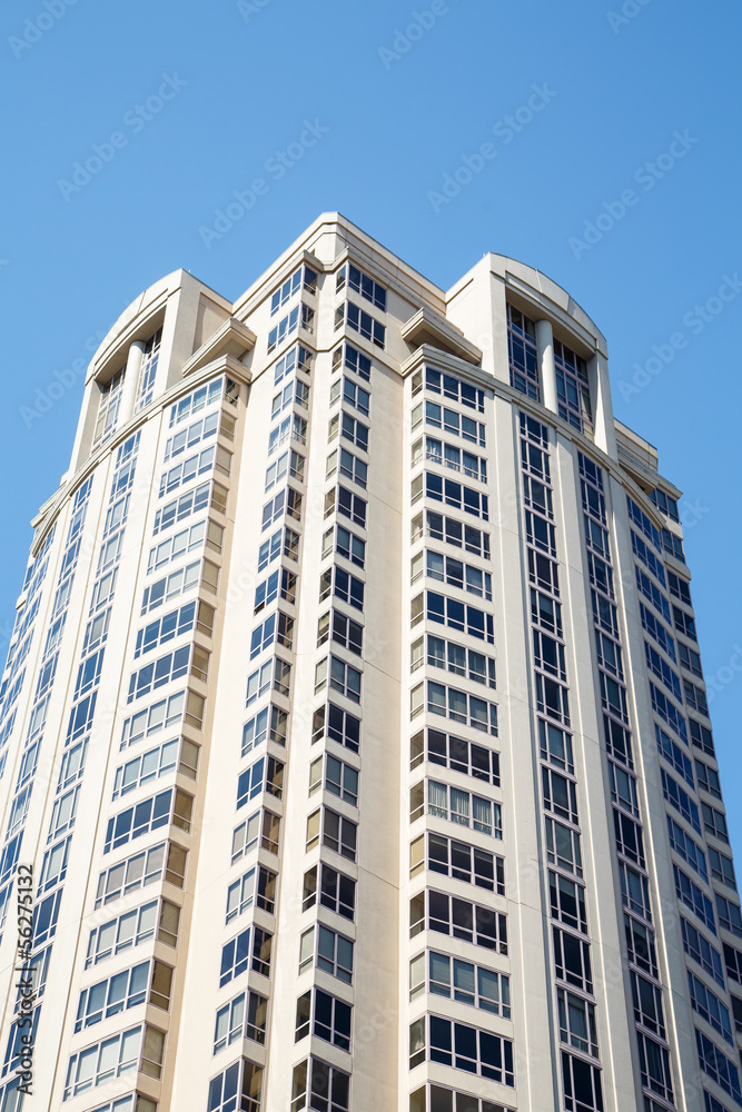 White Condo Tower Under Blue Skies White Condo Tower Under Blue Skies