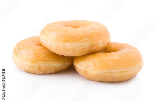 Three doughnuts or donuts piled isolated on white.