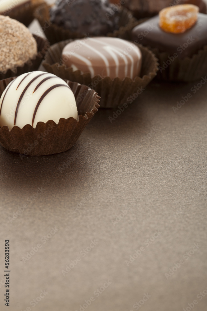 Assorted gourmet chocolate bonbons in paper cups Assorted gourmet chocolate bonbons in paper cups