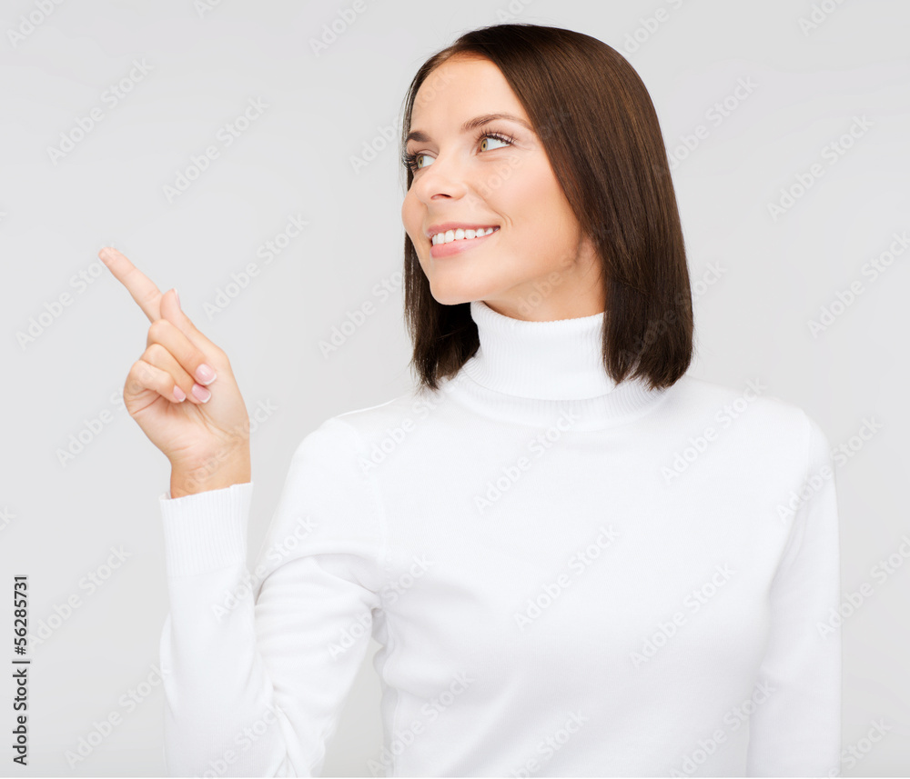 woman in white sweater pointing to something woman in white sweater pointing to something