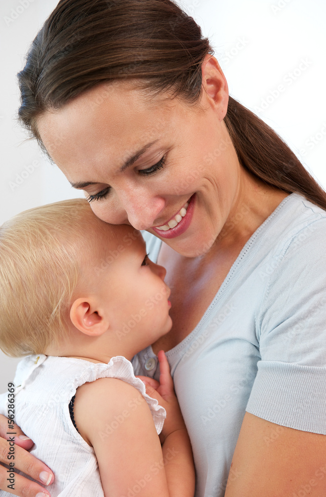 Portrait of a smiling mother hugging cute baby girl Portrait of a smiling mother hugging cute baby girl