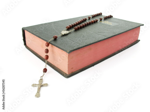 Rosary over an old holy bible.