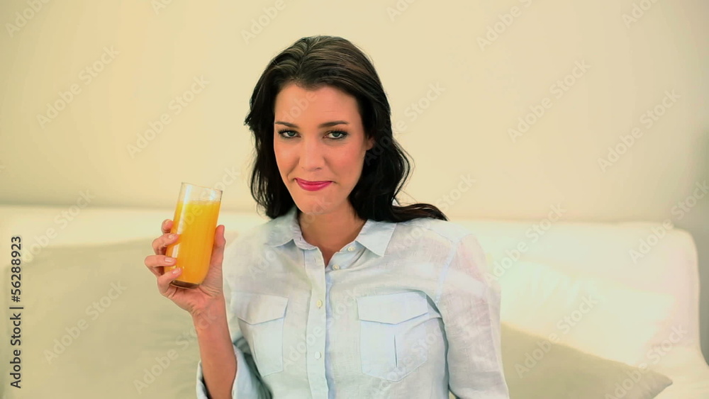 Beautiful brunette drinking a glass of orange juice Beautiful brunette drinking a glass of orange juice