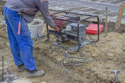 Construction Worker starts the portable Electric Generator 2