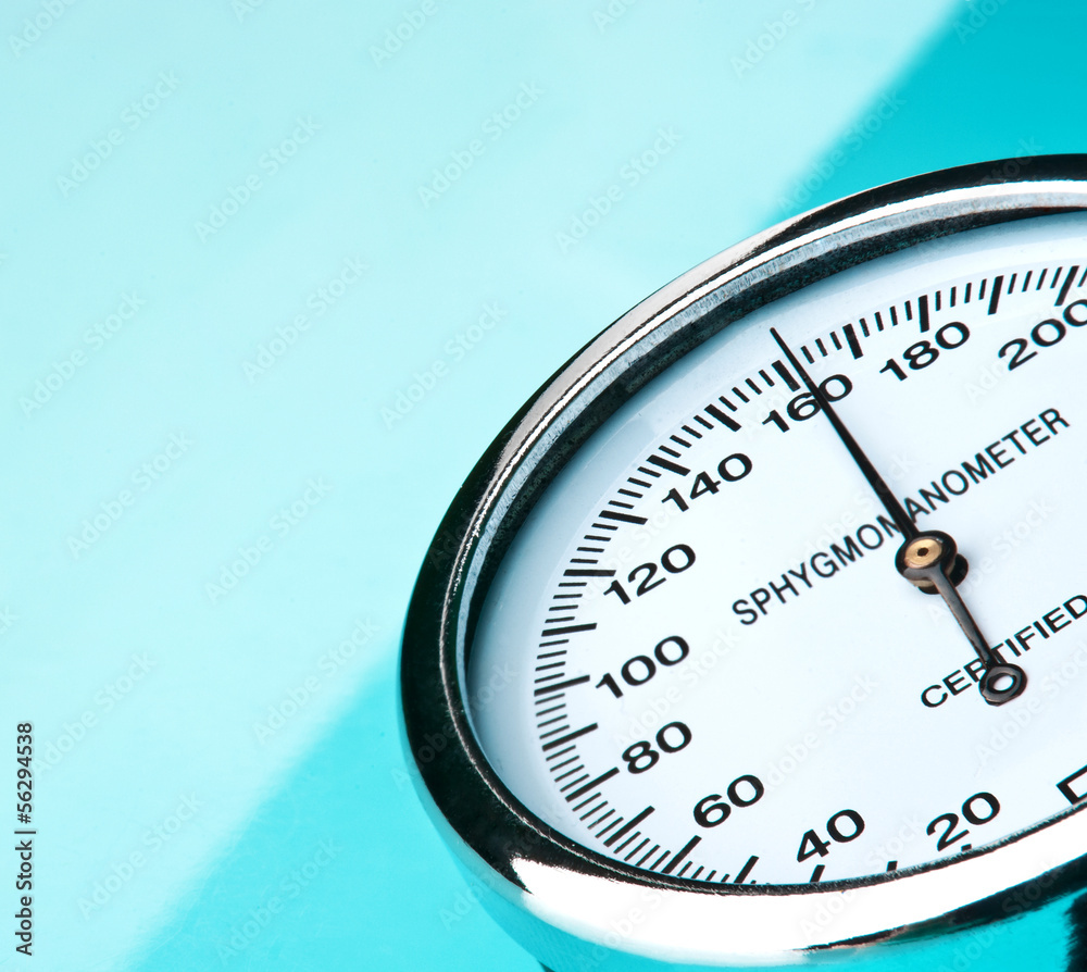 Sphygmomanometer on blue, reflective background Sphygmomanometer on blue, reflective background