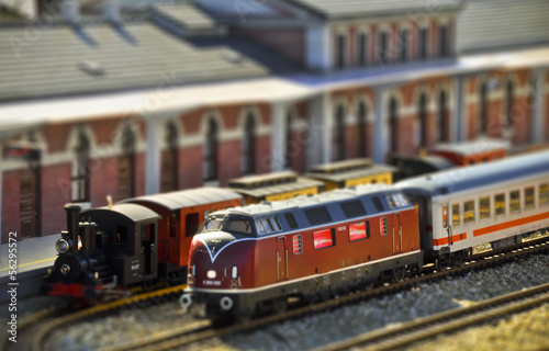 Steam and diesel trains on the railway station. Tilt shift
