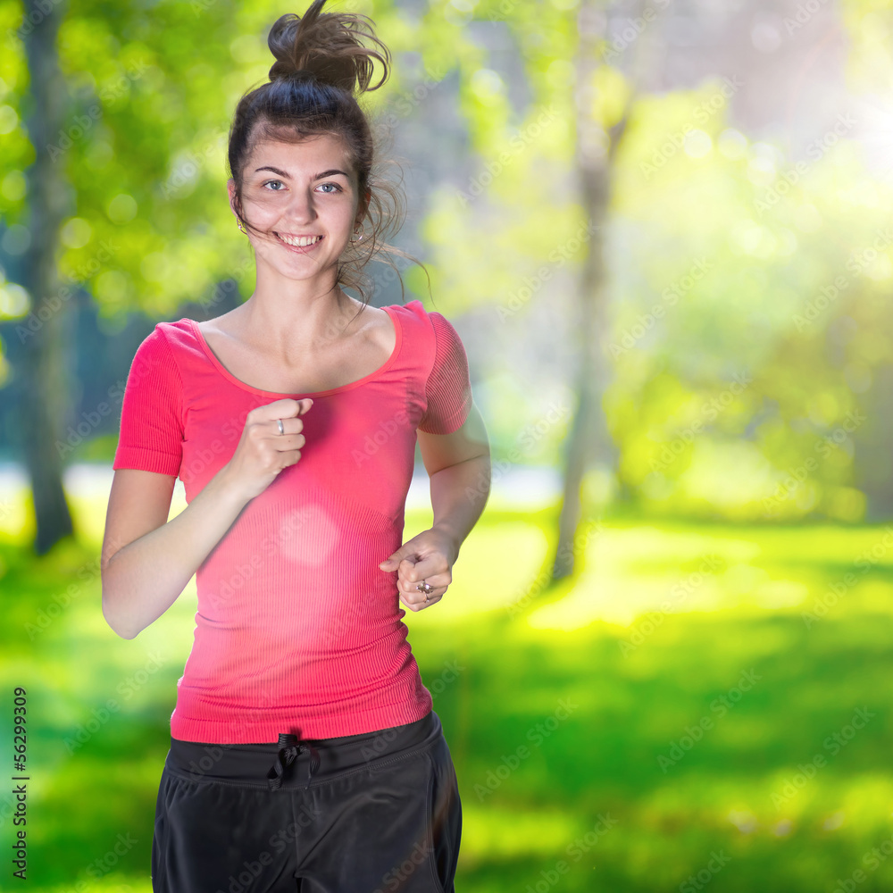 Runner - woman running outdoors in green park Runner - woman running outdoors in green park