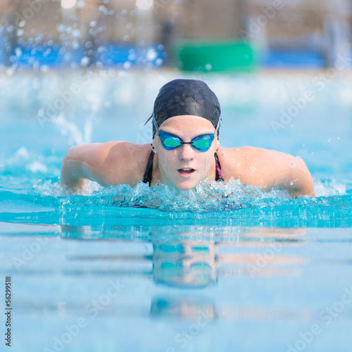 Young girl swimming butterfly stroke style