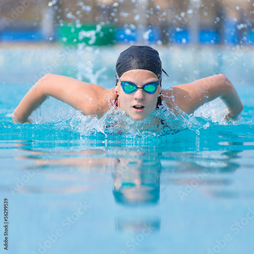 Young girl swimming butterfly stroke style © mr.markin