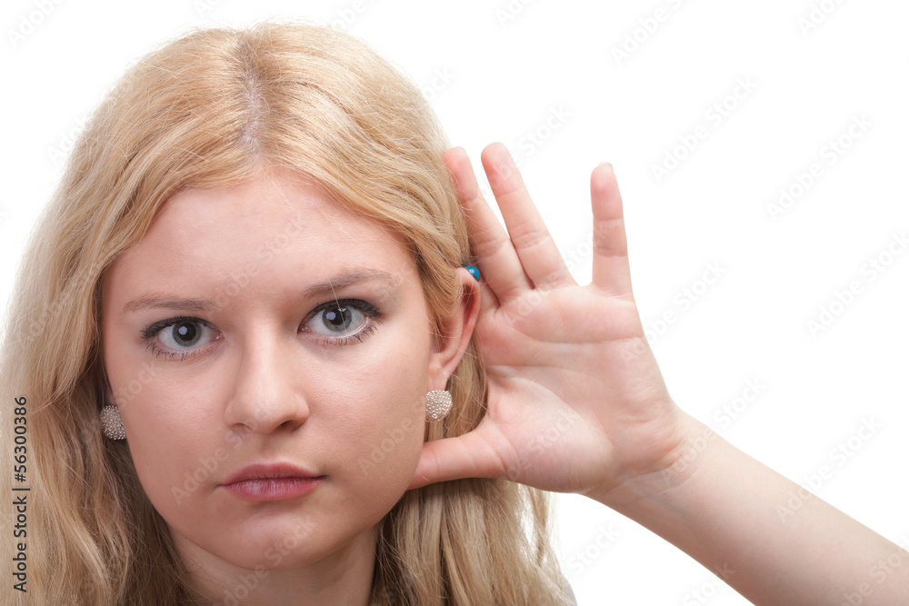 woman eavesdropping with hand behind her ear woman eavesdropping with hand behind her ear