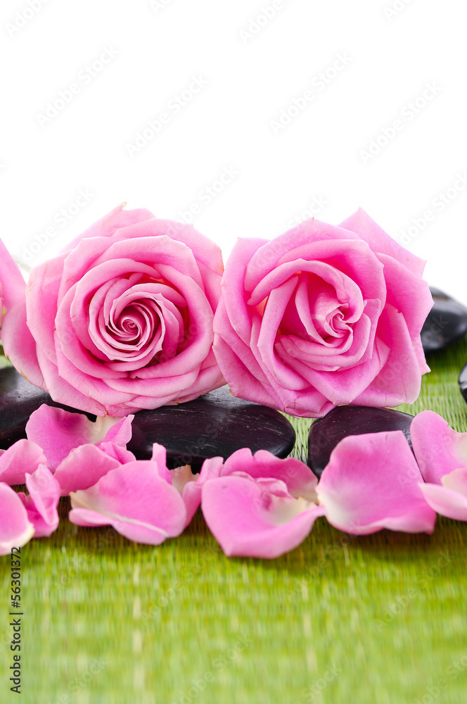 lying down rose with stones on green mat lying down rose with stones on green mat