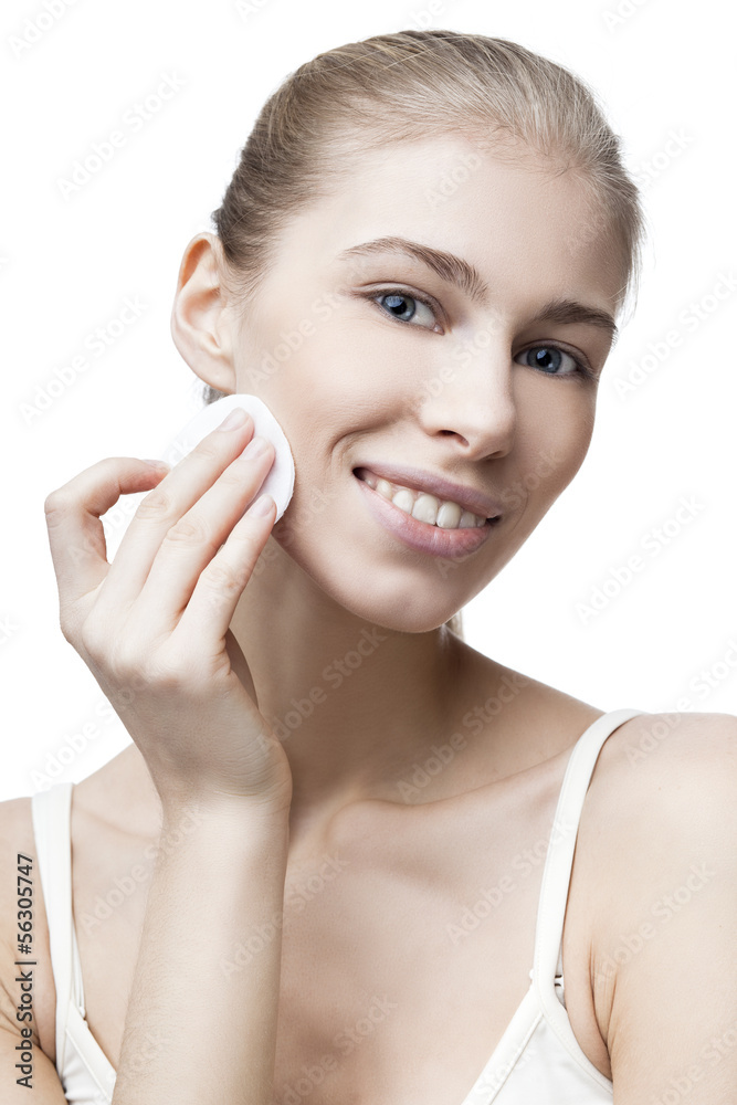 young blond woman with cotton pad