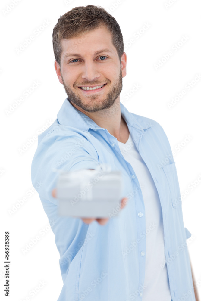 Portrait of smiling young model offering gift Portrait of smiling young model offering gift