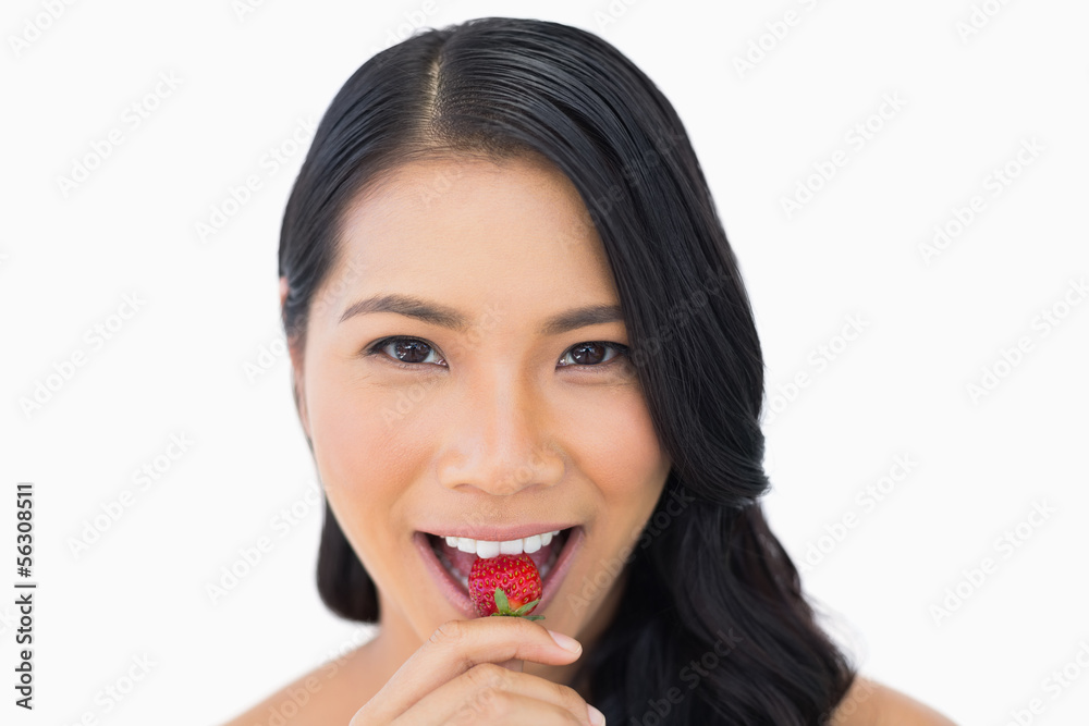 Attractive brown haired model eating strawberry Attractive brown haired model eating strawberry