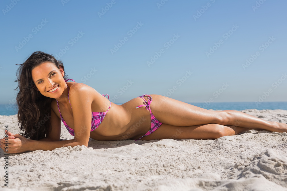 Attractive slim young woman posing while lying