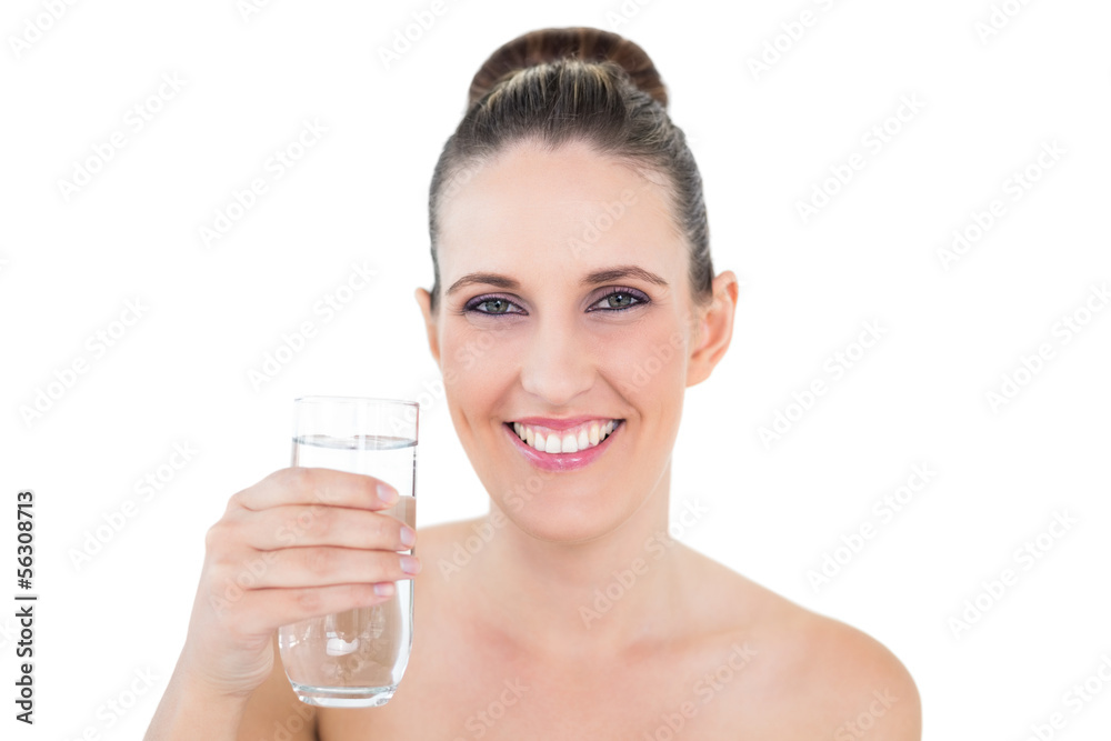 Smiling brunette holding glass of water and looking at camera Smiling brunette holding glass of water and looking at camera