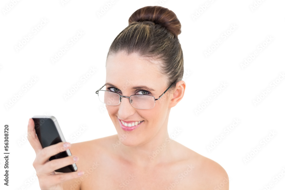 Smart woman with glasses holding phone looking at camera Smart woman with glasses holding phone looking at camera