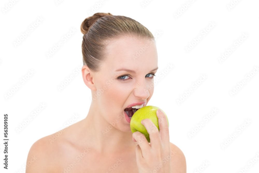 Pretty blonde model eating an apple Pretty blonde model eating an apple