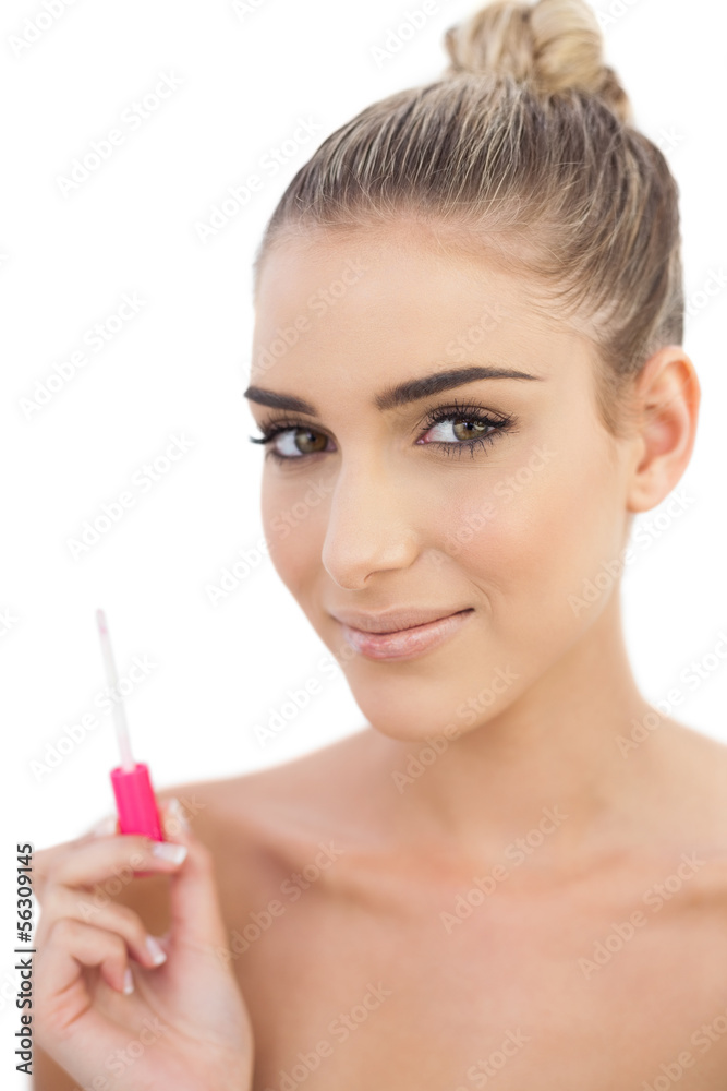 Pleased woman holding a gloss
